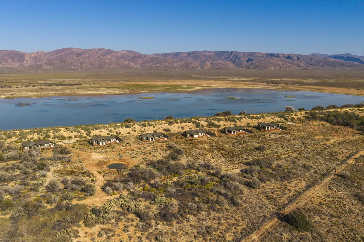 The conservancy and its watering hole beneath the Karoo ranges