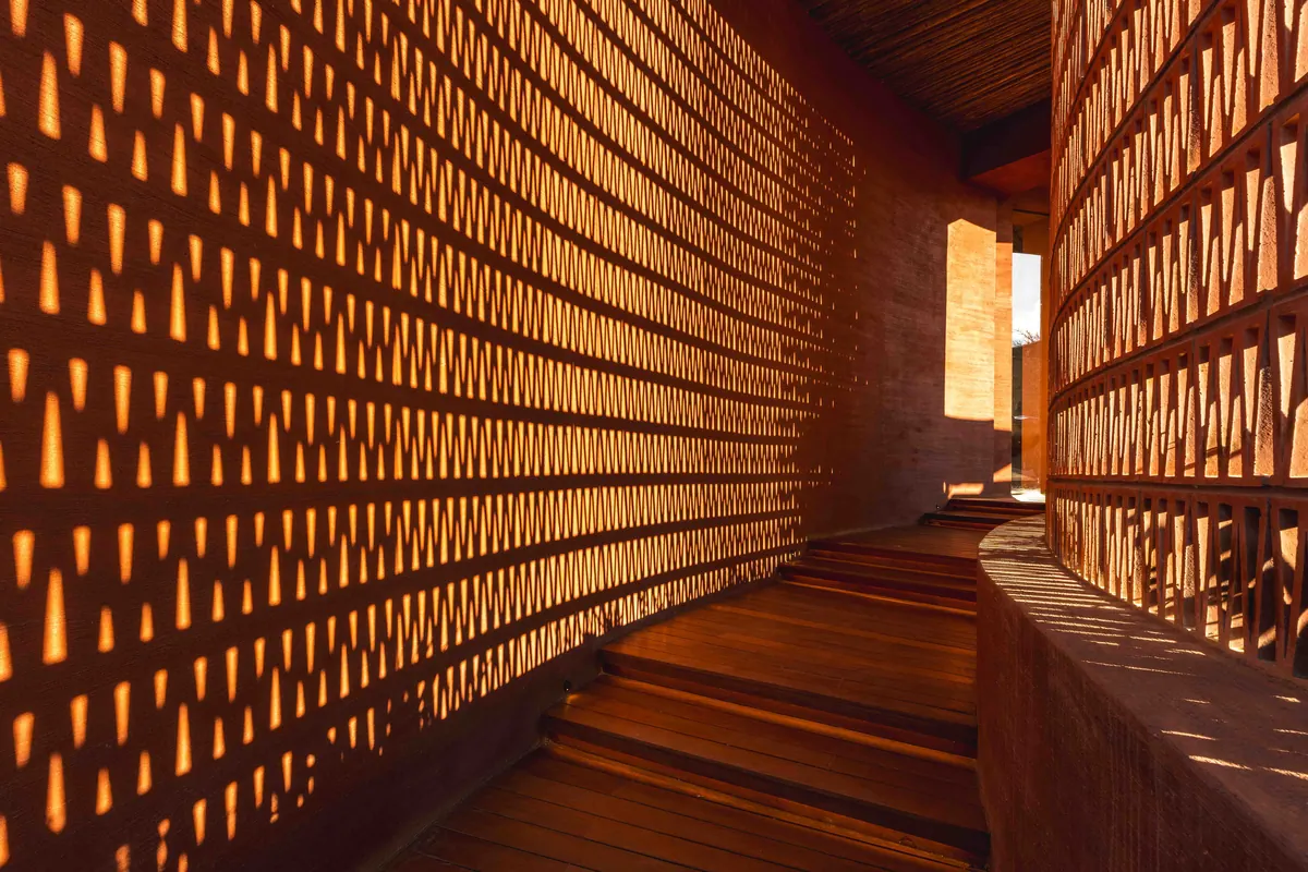 A perforated brick passage casting patterns of light