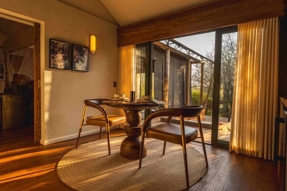 Dining corner with sunlight through linen curtains