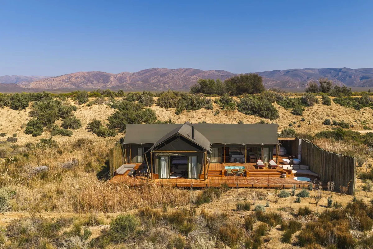 A suite in the dunes with mountains behind