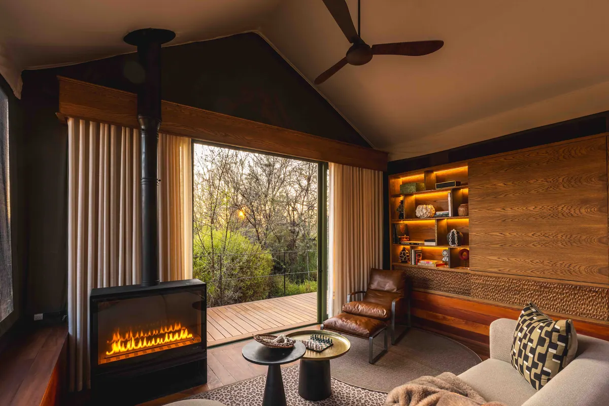Lounge with fireplace opening onto the veld